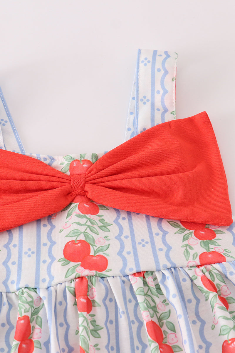 Close-up of apple print fabric and bow on a girls' bloomer set.