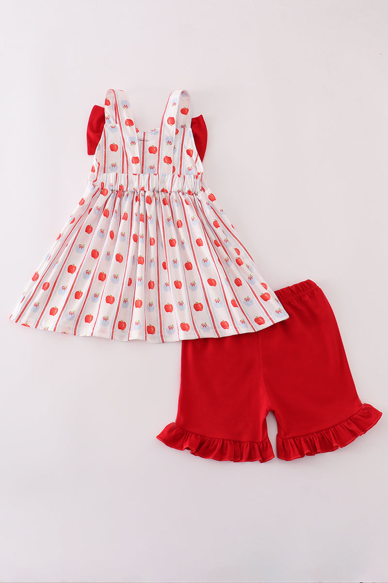 Adorable girls' red shorts set featuring a sweet apple print, ruffles, and a decorative bow.