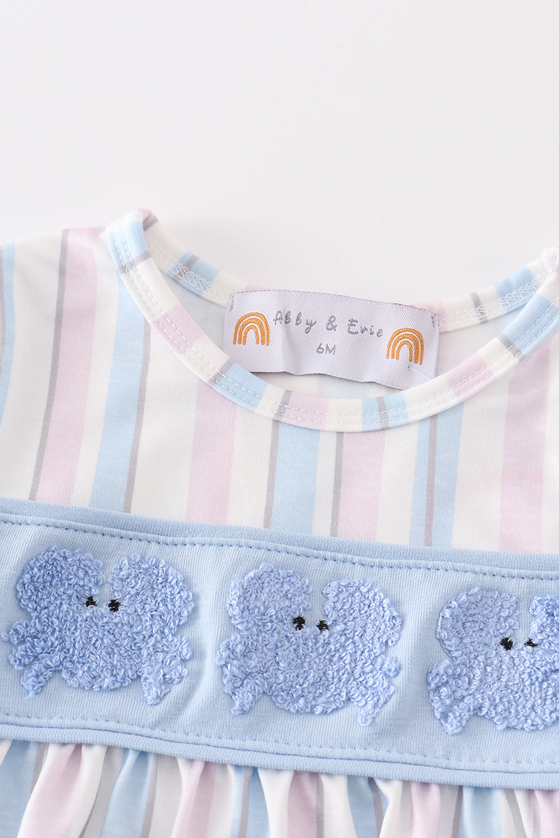 Close-up of a French knot crab embroidery on a girls' striped bubble.