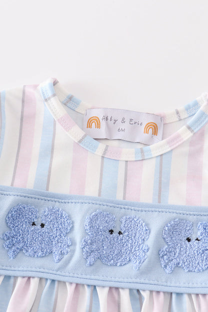 Close-up of a French knot crab embroidery on a girls' striped bubble.