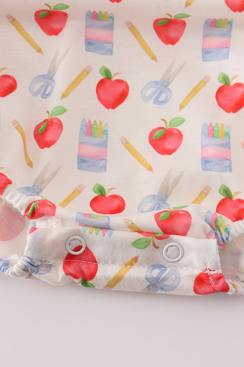 Close-up of apple and pencil pattern on a comfortable children's bubble romper.