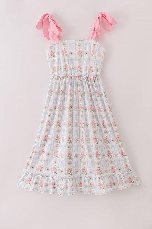Adult tea dress with floral print, bow detail, and ruffle trim.