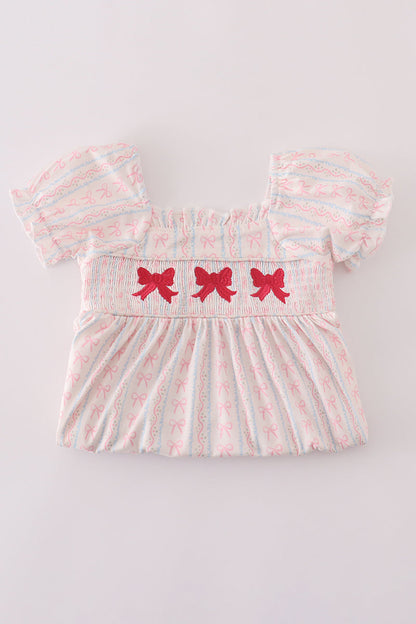 Elegant pink smocked dress for girls featuring bow embroidery.