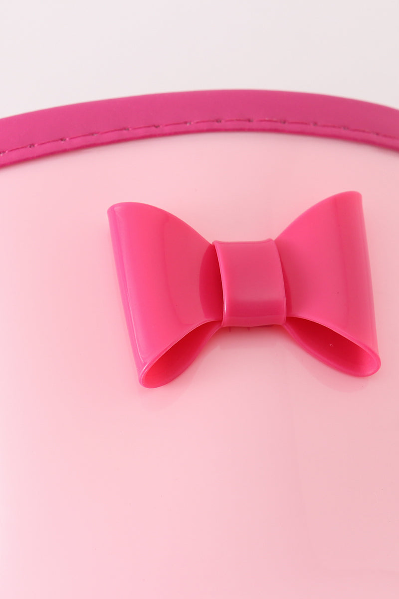 Close-up of a decorative bow on pink rain boots for children.