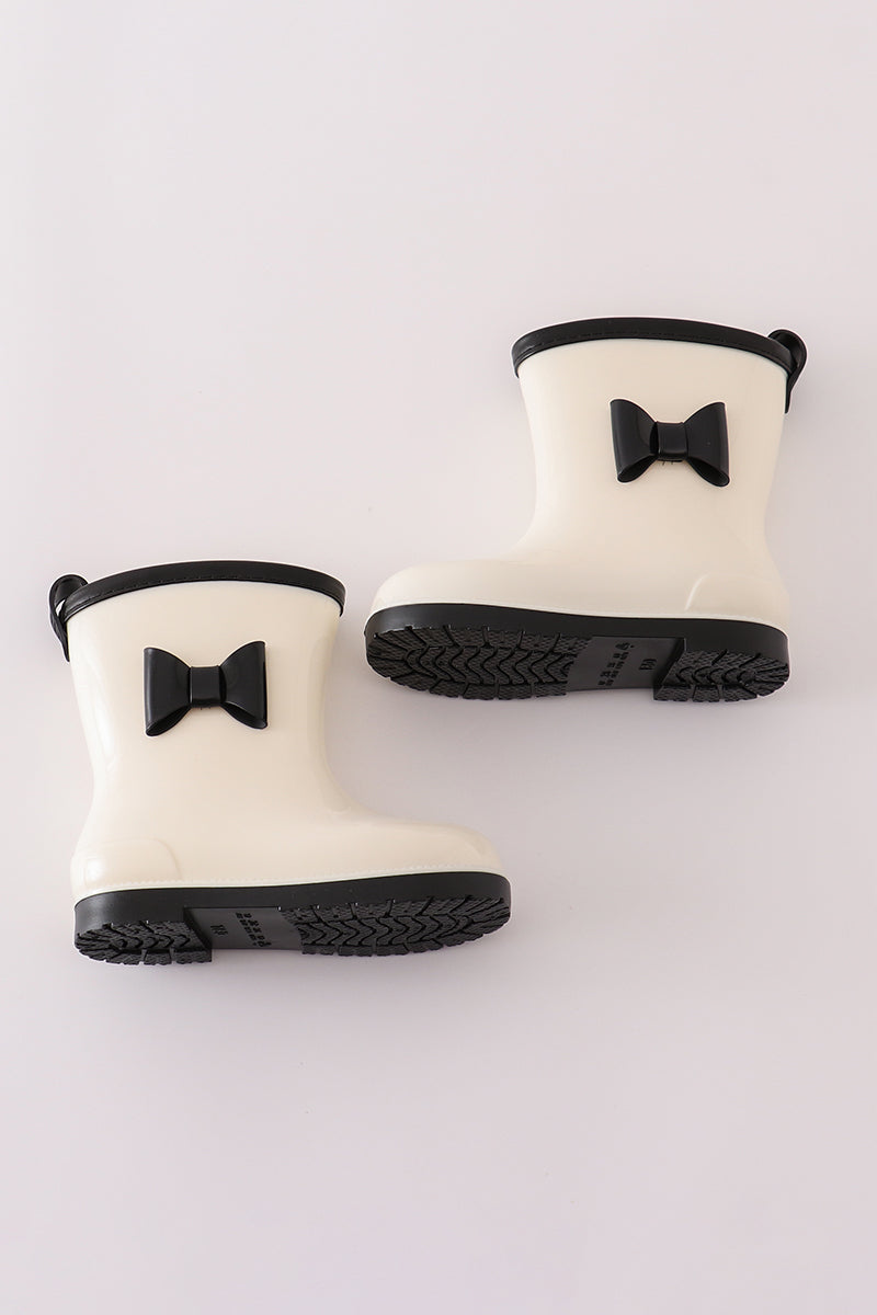 stylish white and black rain boots with bow accents from Cloudling Kids.