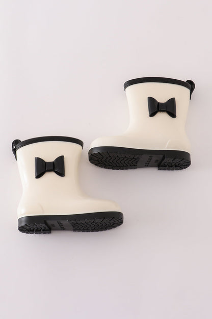 stylish white and black rain boots with bow accents from Cloudling Kids.